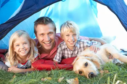Dad with 2 kids and dog in tent