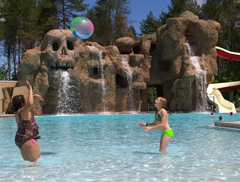 Kids playing with beach ball in pool