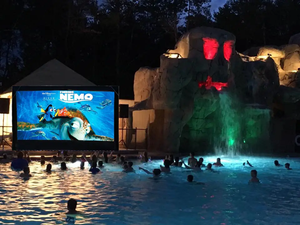 Kids in pool watching movie