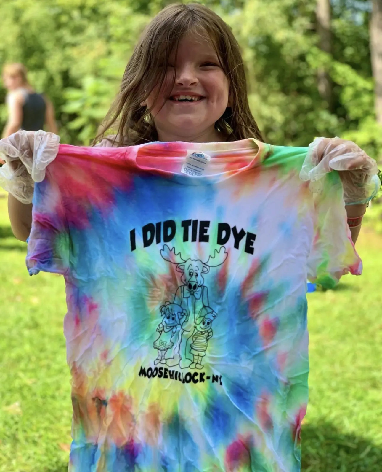 young girl holding tie dye tshirt